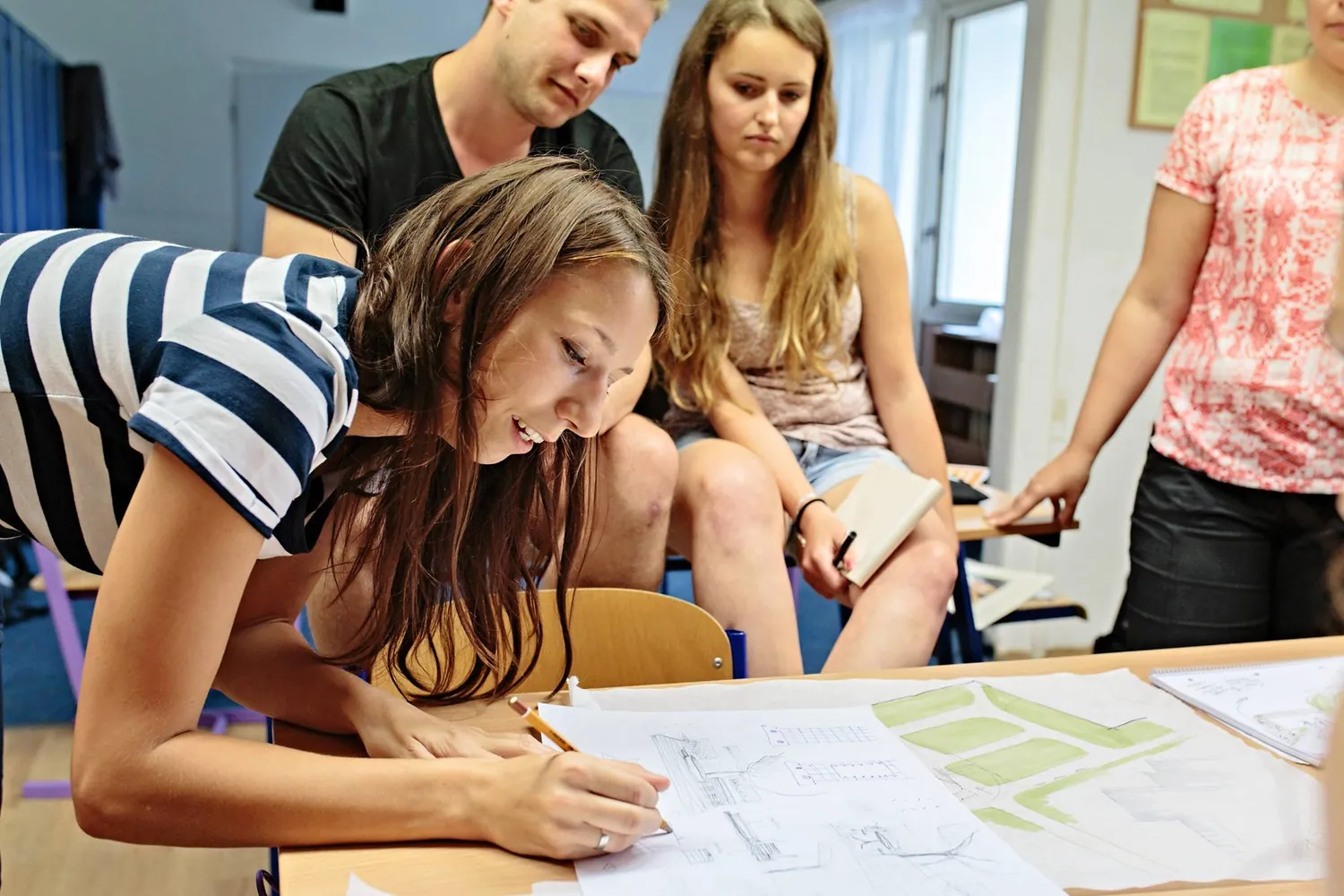 Students drafting the deck design at a table during the workshop
