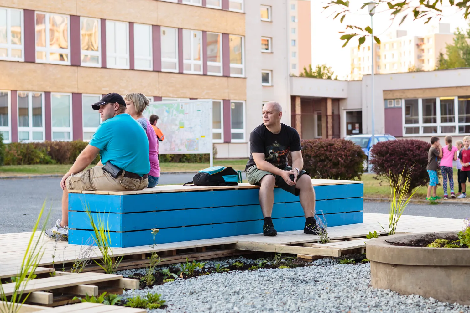 People enjoying the finished deck and its planting