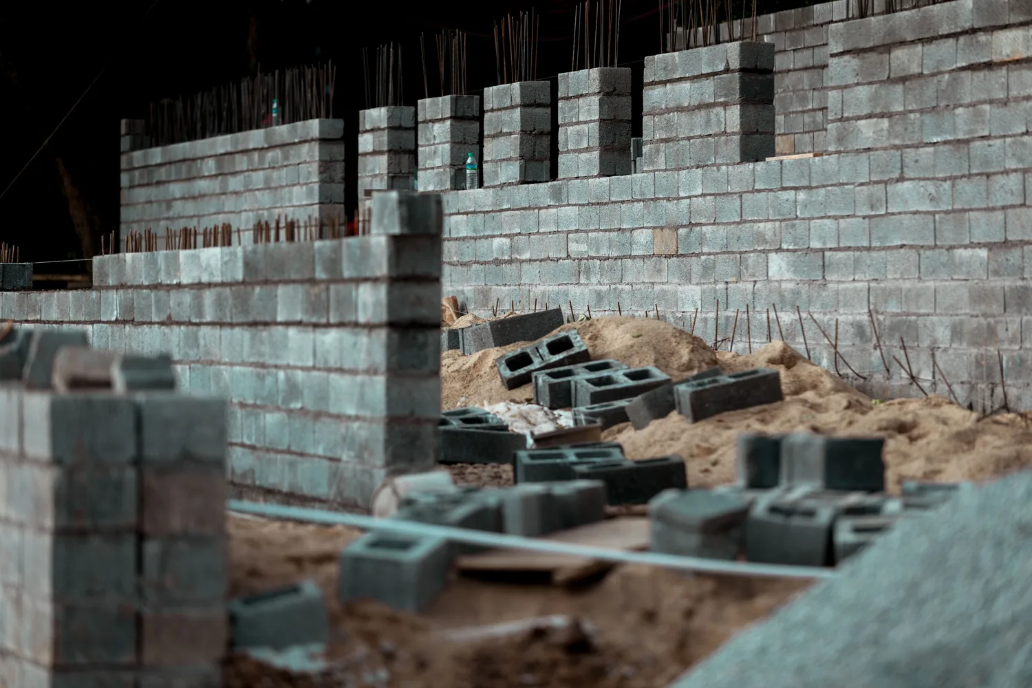 Concrete block walls with reinforcement bars projecting from the top