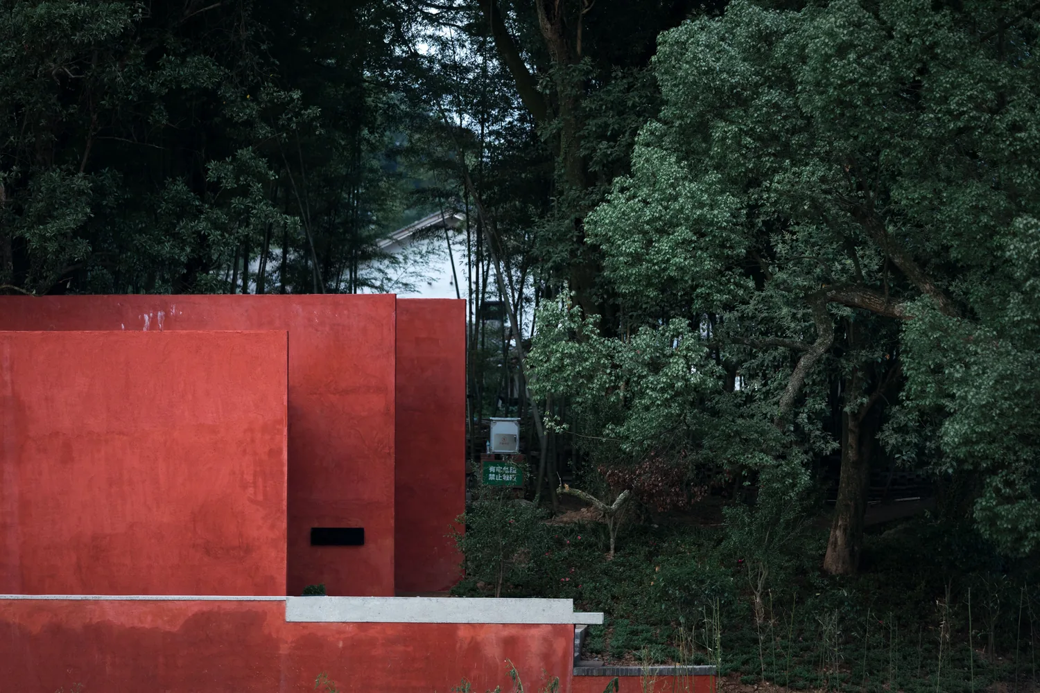 The finished red building among trees